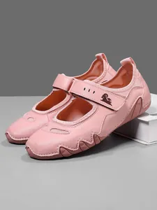 Side profile of pink Mary Jane shoes showcasing the wave-patterned rubber sole detail