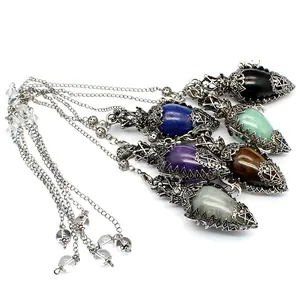 Detail view of ancient silver filigree egg-shaped crystal dowsing pendulums set.