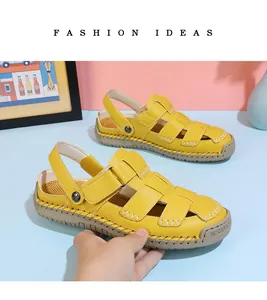 Detailed view of yellow leather fisherman sandals with white contrast stitching
