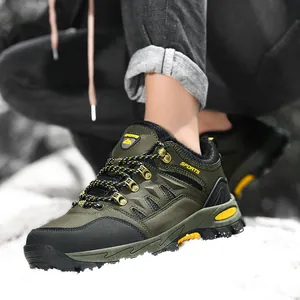 Detailed side view of durable olive green low-top outdoor hiking shoes displayed on snow