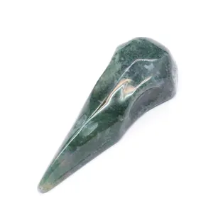 Detailed macro view of a polished green moss agate natural stone bird skull carving