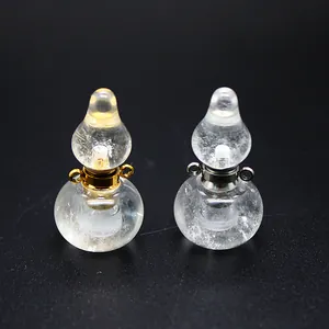 Macro view of clear crystal gourd-shaped mini perfume bottle pendants with metal loops