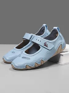 Close-up view of light blue Mary Jane walking shoes featuring velcro straps and mesh panels
