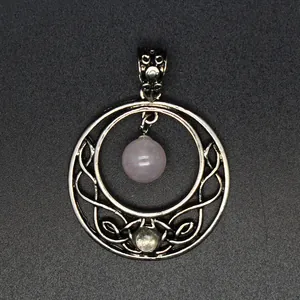 Macro view of Celtic knot moon pendant with pink quartz bead and silver finish