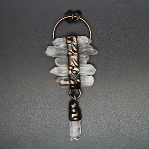 Detail shot of a vintage clear quartz crystal tassel pendant with antique metal finish