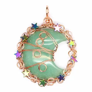 Detailed macro shot of handmade wire-wrapped green aventurine moon pendant with stars
