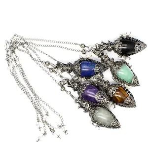 Detailed view of antique silver egg-shaped crystal pendulum pendants in various stones