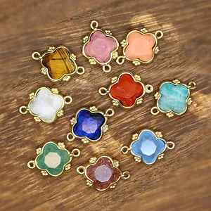 Close-up of colorful natural stone clover charms with 18K gold-plated beaded frames.