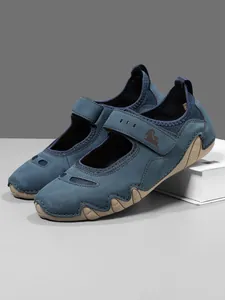 Close-up of blue women's Mary Jane sport sneakers with wavy sole and Velcro strap