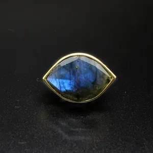 Detailed view of faceted blue labradorite stone in a gold Eye of Horus ring.