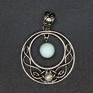 Detailed view of a silver hollow moon pendant featuring a natural pale blue stone.