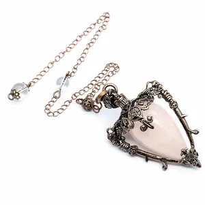 Detailed view of medieval retro rose quartz pendulum necklace with ornate bronze frame