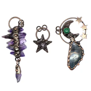 Detail showing three vintage handmade natural stone pendants with moon and stars