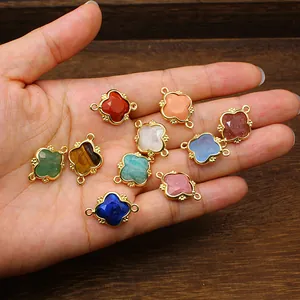 Detailed close-up of various natural stone clover charms with elegant gold frames