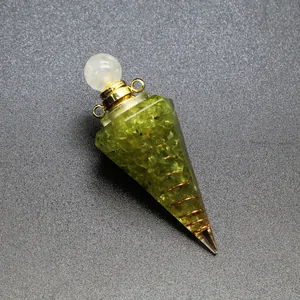 Detail of resin hexagonal cone filled with green peridot chips and copper coil.