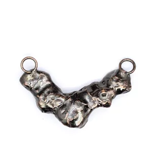 Detailed view of a vintage style metallic raw stone effect pendant connector with two loops.