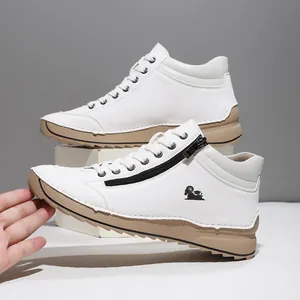 Detail view of white casual sneakers featuring a side zipper and hand-stitched sole.