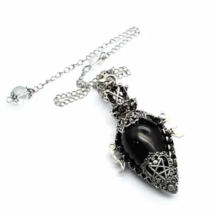 Detail of antique silver egg-shaped black stone pendulum with pentagram engraving