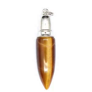 Vertical detail of a polished tiger's eye stone bullet-shaped jewelry pendant charm