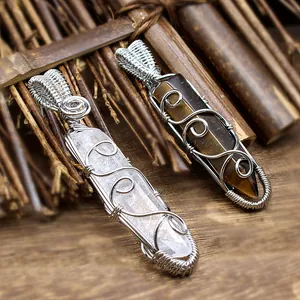 Detailed macro view of handmade wire-wrapped hexagonal crystal stone pendants