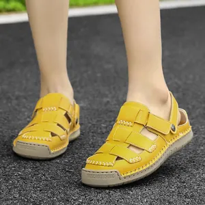 Bright yellow women's fashion summer sandals featuring hollow weave and non-slip rubber sole