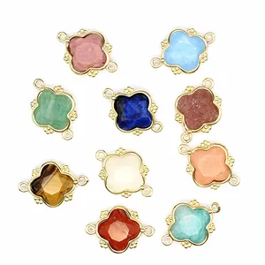 Detailed macro shot of various colorful natural stone clover connectors for DIY jewelry.
