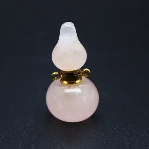 Close-up of a natural rose quartz gourd perfume bottle pendant with gold hardware