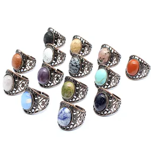 Collection of vintage filigree rings with various natural gemstones on white background