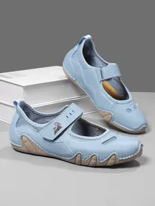 Detail view of light blue Mary Jane sandals with adjustable velcro strap and rubber sole