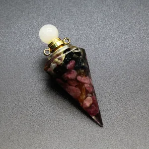 Detailed view of resin hexagonal pyramid bottle filled with tourmaline crushed stones