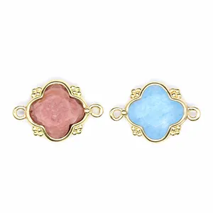 Macro view of pink and blue natural stone flower charms with 18K gold plated double loops