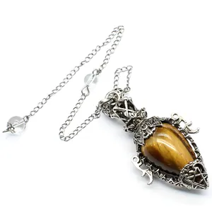Detailed view of tiger's eye egg crystal pendulum pendant with antique silver frame