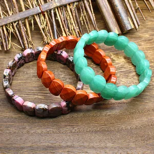 Set of three natural stone bracelets featuring faceted segments in pink orange and green