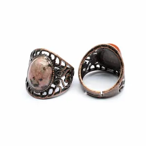 Detailed view of vintage hollow metal ring with natural pink stone and adjustable band