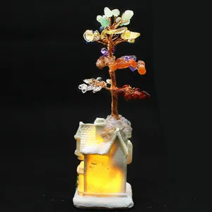 Close-up detail of seven chakra crystal money tree with glowing cabin base for home decor