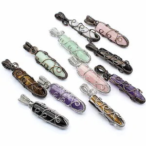 Variety of wire wrapped natural stone hexagonal crystal pendants on white background