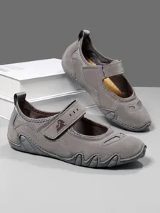 Detailed view of grey sporty Mary Jane shoes with velcro straps and textured soles