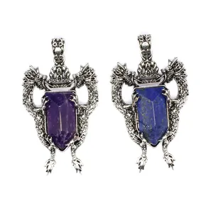 Detail of vintage double dragon shield pendants with natural crystal and lapis lazuli