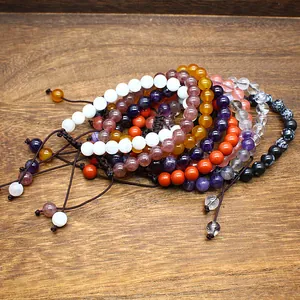 Close-up of assorted 8mm natural stone beaded bracelets with handmade woven cord