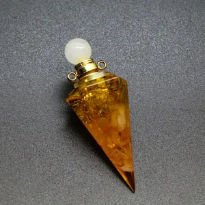 Close-up of hexagonal resin perfume bottle pendant with yellow crushed stone and gold foil