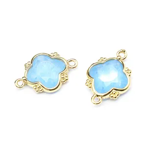 Detail view of two light blue moonstone flower connectors with 18K gold plating.