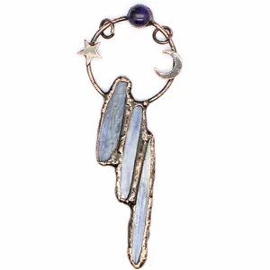 Detail view of celestial vintage pendant with blue kyanite and star moon accents