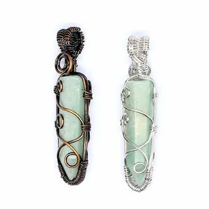 Detailed view of handmade wire-wrapped crystal pendants in copper and silver wire.
