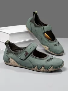 Detailed view of green women's sporty Mary Jane sandals with Velcro strap