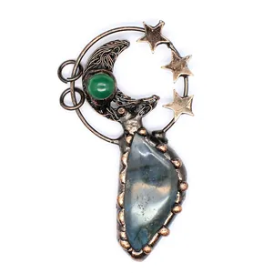 Detailed macro view of retro bronze moon and star pendant with iridescent labradorite stone