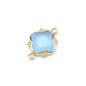 Detail of light blue moonstone 18K gold plated flower pendant with double loops.