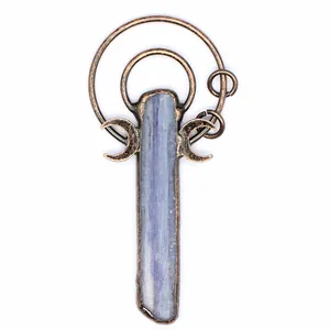Close-up of a long blue kyanite stone pendant with a vintage copper moon frame