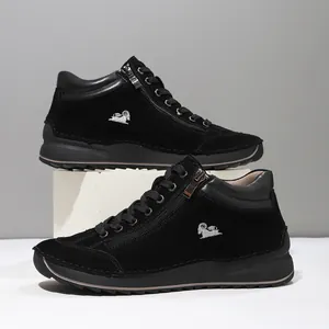 Detailed macro view of black hand-stitched high-top casual shoes with silver logo