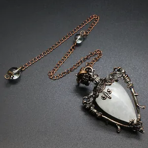 Close-up of vintage bronze pendulum necklace with white teardrop natural stone detail.