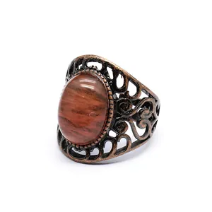 Detailed view of a vintage filigree ring with a large oval natural stone inlay
